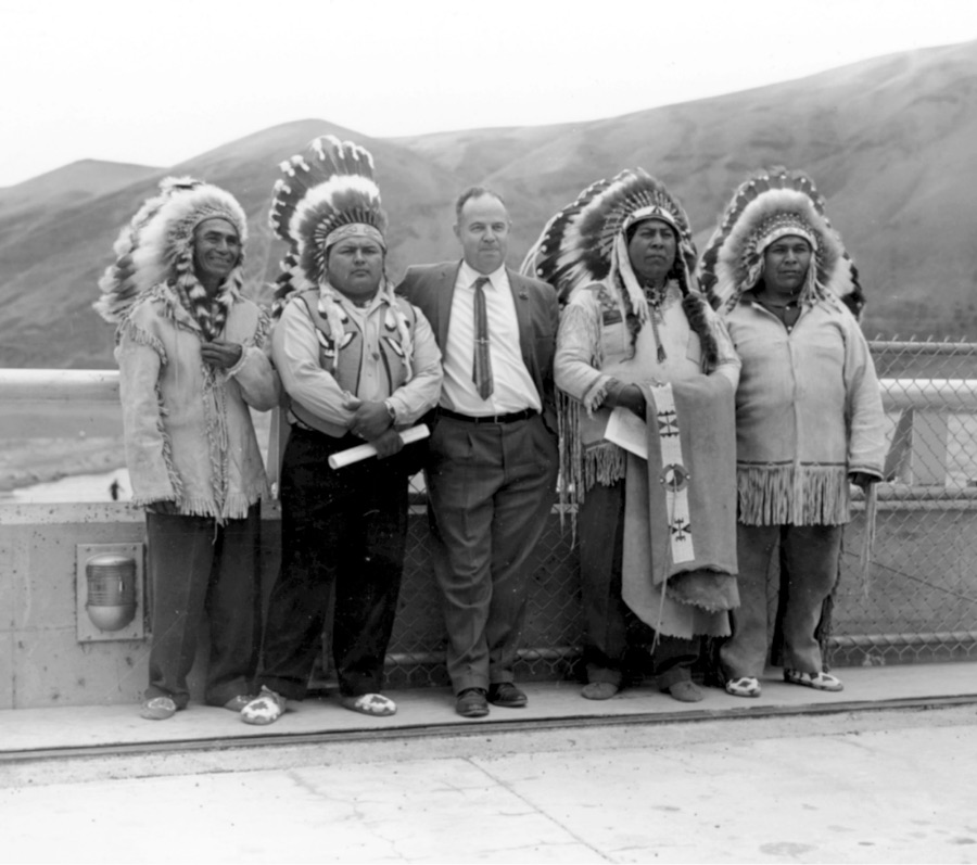 Historical black and white photo of Wanapum in regalia standing with a man in a business suit.