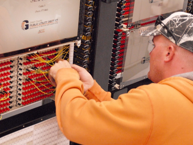 Grant PUD employee working with fiber connections