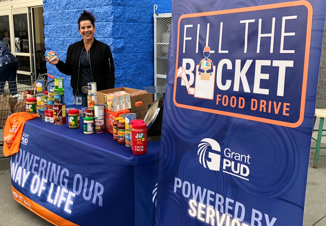 Grant PUD employee collecting food at the Fill the Bucket food drive.