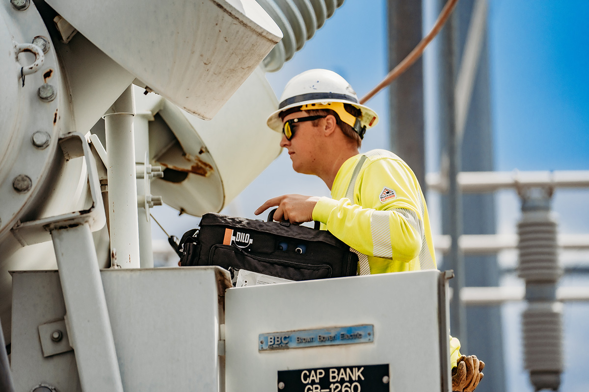 Grant PUD employee wearing harness and hard hat