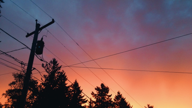 overhead power lines with sunset in background